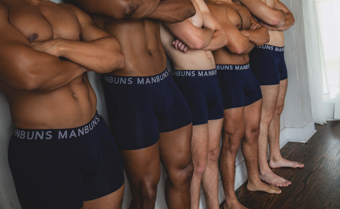 Five male models standing side by side with arms crossed, wearing MANBUNS Midnight Navy Blue Boxer Briefs featuring a branded waistband and a modern, fitted design.