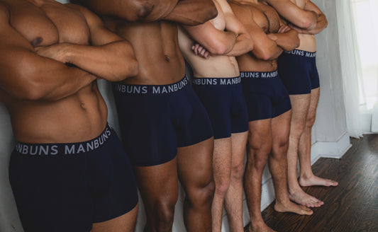 Five male models standing side by side with arms crossed, wearing MANBUNS Midnight Navy Blue Boxer Briefs featuring a branded waistband and a modern, fitted design.